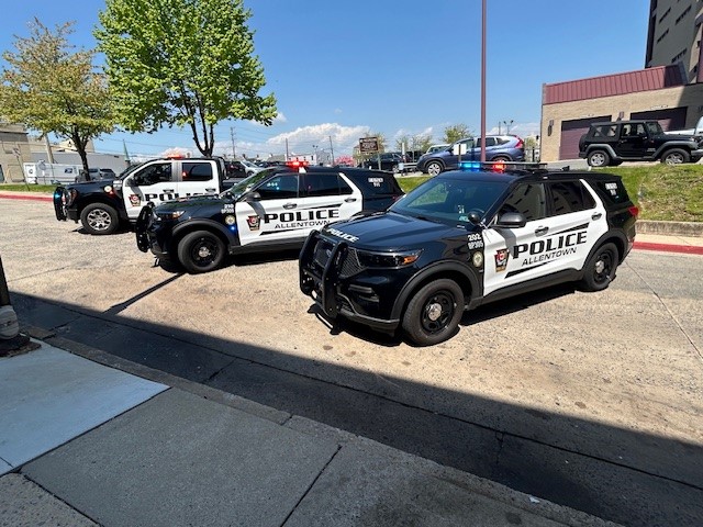 An APD truck and two APD SUVs adorned in the new black and white livery.
