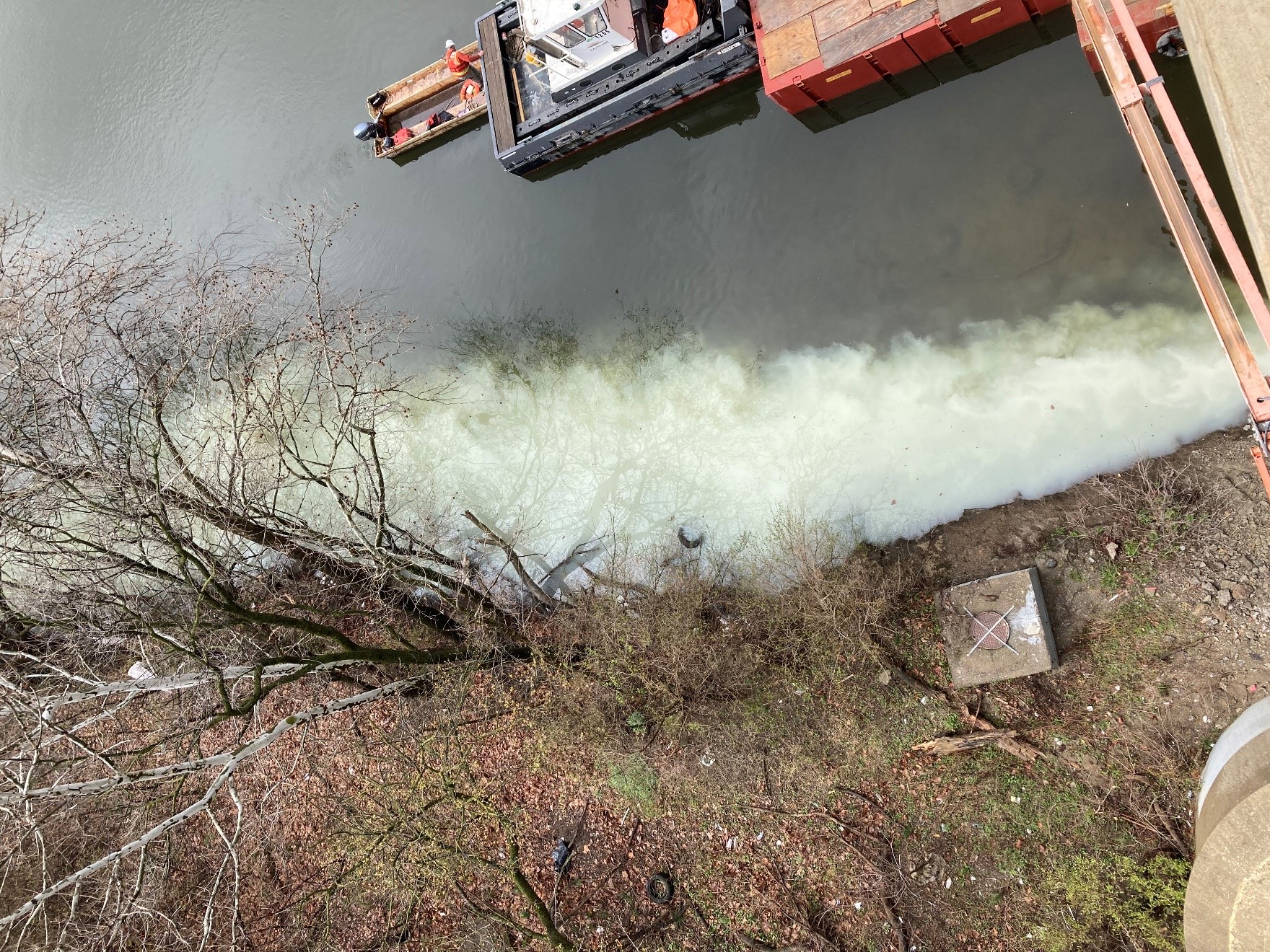 Polluted water along the shore of a waterway.